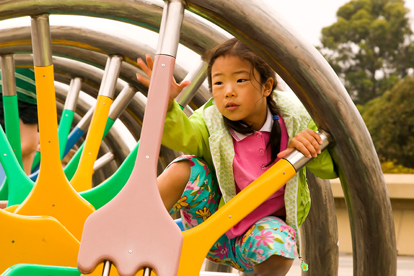 A child climbing on the DNA sculpture exhibit at The Lawrence