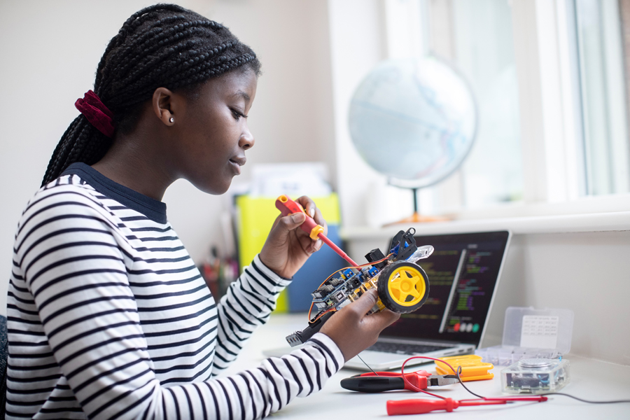 A student building a model robot car